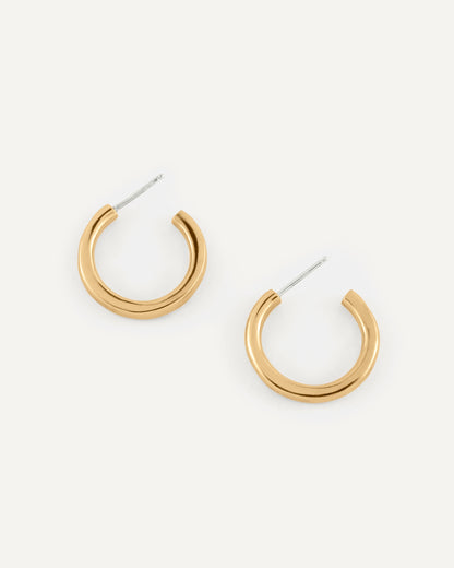 A pair of organic and fluid shape brass hoops in high polished finish.