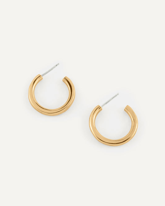 A pair of organic and fluid shape brass hoops in high polished finish.