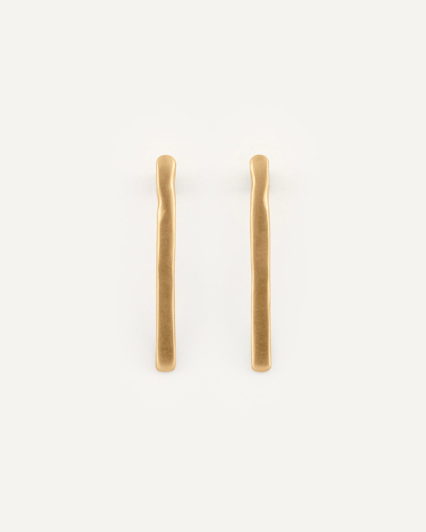 A pair of straight line with soft curved earrings in soft satin finish.