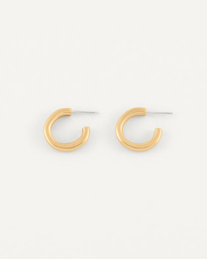 A pair of organic textured and fluid formed brass hoops in soft satin finish.